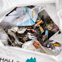 Fimpar, plastgaffel och annat skräp i en plastpåse.