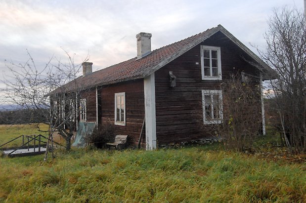 Bledäng 1:8. Byggnad i brunt timmer i två våningar, två skorstenar och fönster med vita spröjs.